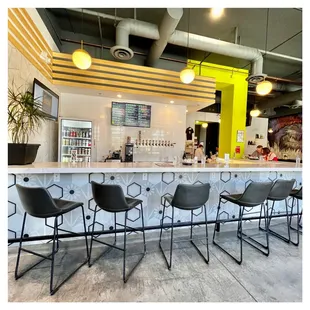 a row of bar stools at a crafthaus arts district