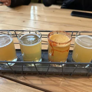 four different beers in a metal basket