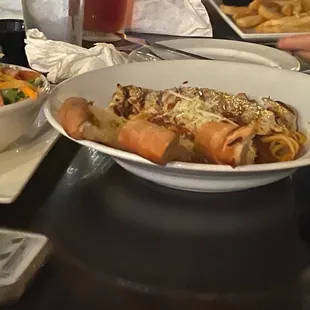 a plate of pasta and a bowl of salad