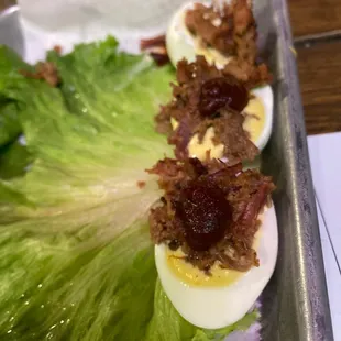 a tray of deviled eggs and lettuce