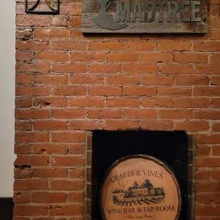 a wine barrel in front of a brick wall