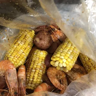 1 lb Shrimp, 1/2 lb sausage, and corn in Fire Boom Sauce