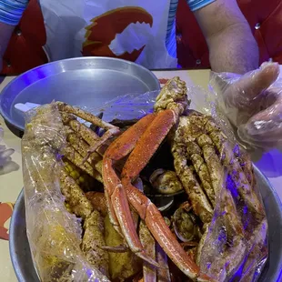 a person holding a bowl of crab