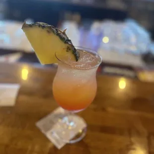 a drink with a pineapple garnish