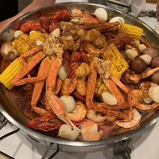 crab legs, corn, potatoes, and corn on the cob