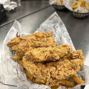 a basket of fried fish and fries