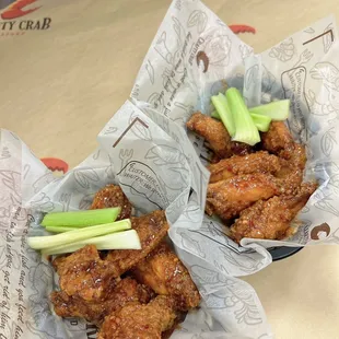 two baskets of chicken wings and celery