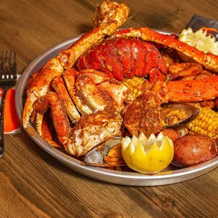 a plate of crab legs and corn on the cob