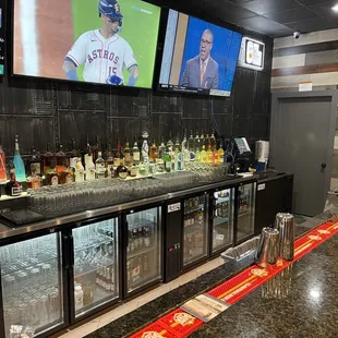 Full bar lot of choices of beer bottles, drafts and liquors!