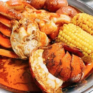 a plate of crab - wauwatosa with corn and potatoes