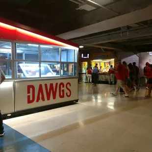 a group of people walking around a food truck