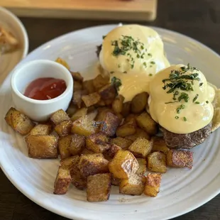 Steak Benedict with roasted potatoes, very rich and hearty, from their brunch menu. Potatoes are soft and smoky.