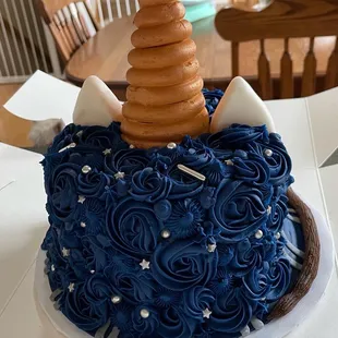a cake with blue frosting and a brown icing