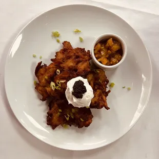 Potato latkes with cream and caviar with a side of applesauce