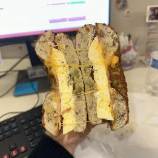 Egg ham and cheese on a pesto bagel with mayo