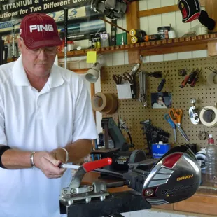 Dave re-gripping clubs in the shop