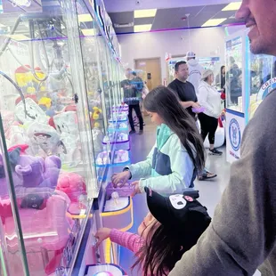 Kids playing crane machines