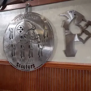 a metal sign hanging on a wall