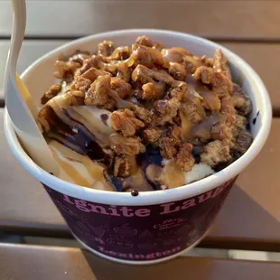a cup of ice cream with nuts on top