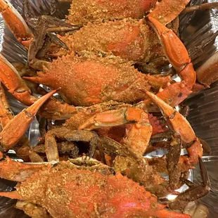 cooked crabs in a foil container