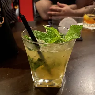 a glass of mojita with mint leaves