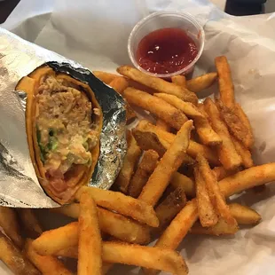 Spicy buffalo chicken wrap and fries. Sorry forgot to take pictures before I ate 1st half.