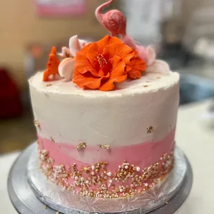 a cake decorated with pink and orange flowers