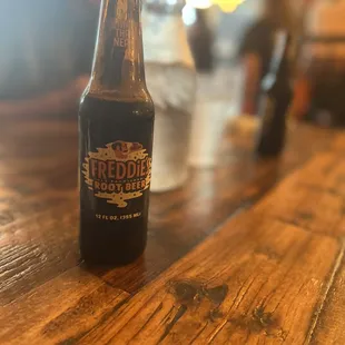 a bottle of beer on a wooden table