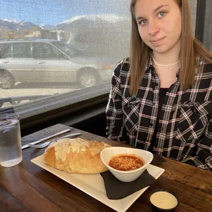 a woman sitting at a table with a plate of food