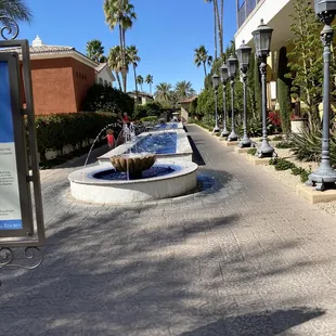 a fountain in the middle of a courtyard
