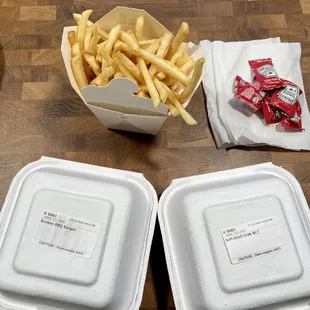two burgers and fries to go