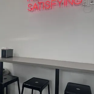 a neon sign that reads huge &amp; satisfyinging