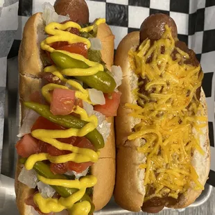 two hotdogs with mustard and ketchup