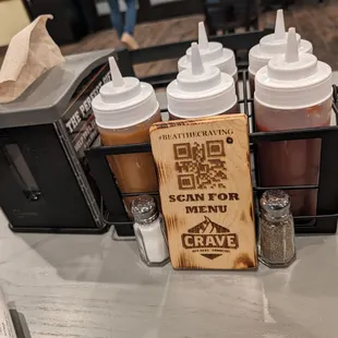 a barbeque table with a variety of condiments