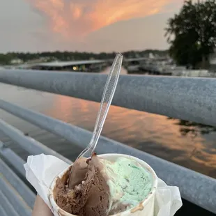 a person holding a bowl of ice cream