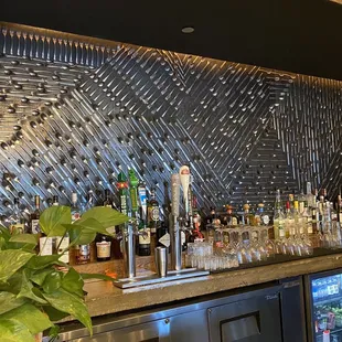 The wall behind the bar - it's all cutlery!