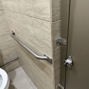 Clean ladies restroom with convenient bars to assist the elderly or disabled