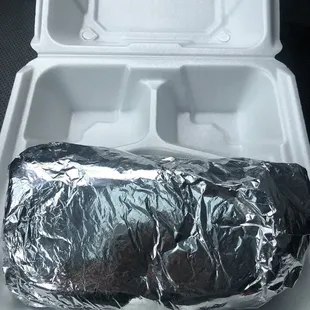 a burrito wrapped in aluminum foil