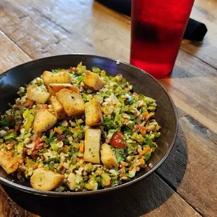  bowl of food on a wooden table