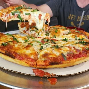  man eating a slice of pizza