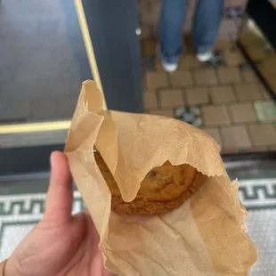 a person holding a bag of food