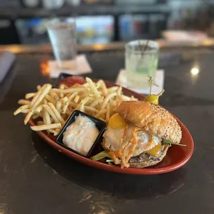 a burger and fries on a red plate