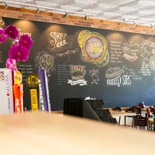 a restaurant with a chalkboard wall