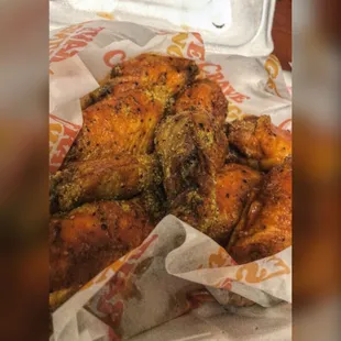 a closeup of a basket of chicken wings