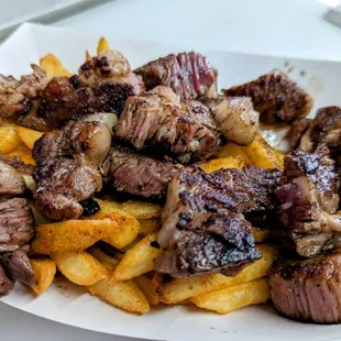 a plate of meat and fries