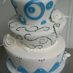 blue and emerald green mad hatter style wedding cake
