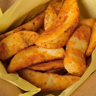 Seasoned Potato Wedges baked in the oven served with ketchup