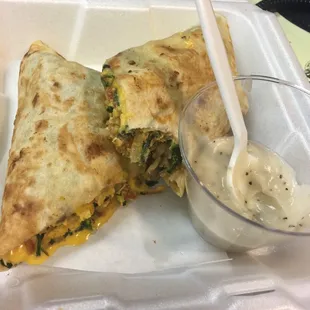 two quesadillas with a side of sour cream