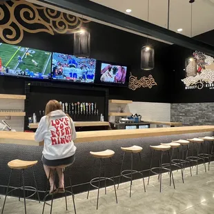 a woman watching a football game on tv