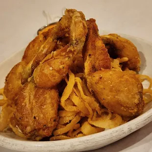 Frogs on a Mound (fried frog legs on a mound of onion strings)